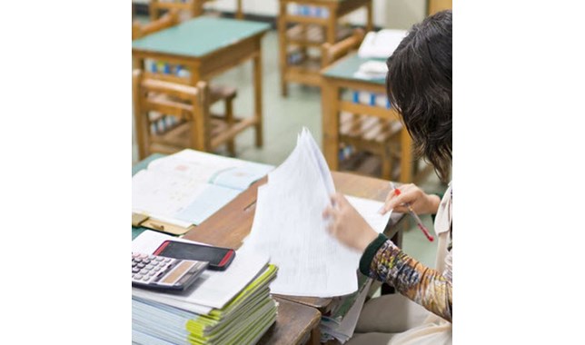 Teacher looking at the tests